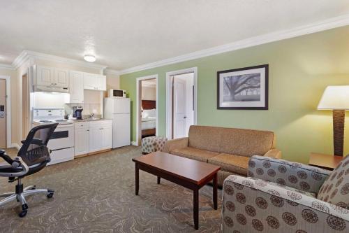 a living room with a couch and a table at Best Western PLUS Mirage Hotel and Resort in High Level