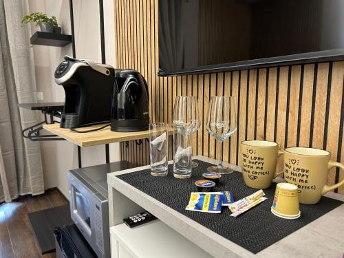 a counter with two glasses and a coffee maker at La Dimora del Re in Rome
