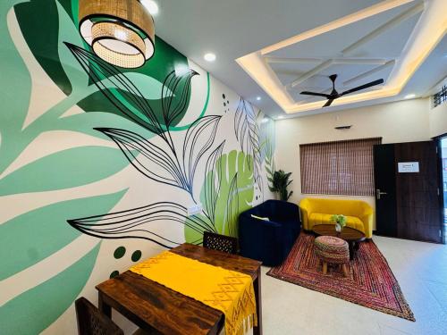 a living room with a colorful mural on the wall at Home Escape 2BHK Retreat Pvt Home in Ujjain