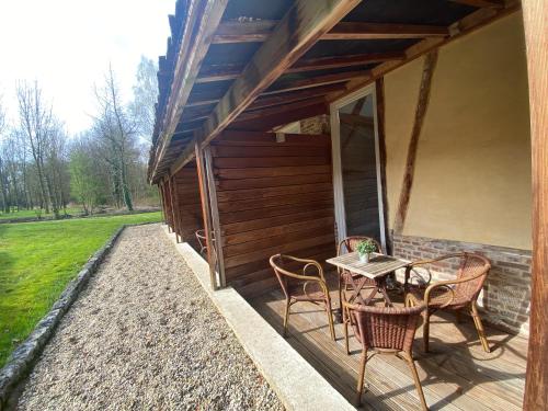 a porch of a house with a table and chairs at Landgoed De Hoogmolen in Oudsbergen 