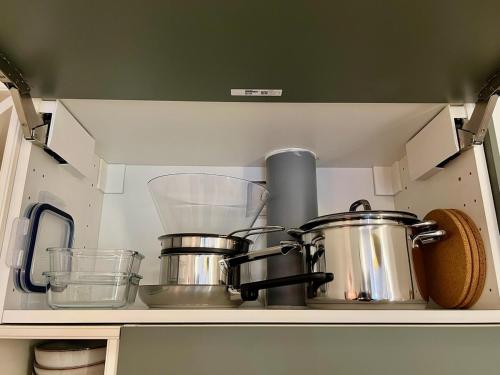 a kitchen shelf with pots and pans on it at Tuscana-style house Boulay in Boulay - Moselle
