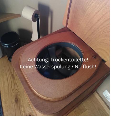 a wooden toilet seat with the words nothingtocologicallyhibited kite wasasuring at Villa Mara in Perchtoldsdorf