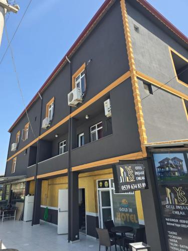 a large black building with a lot of windows at Gold in Confort hotel in Barbaros