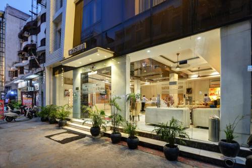 a store with potted plants in front of a building at Hotel Krishna - By RCG Hotels, Centrally Located, New Delhi in New Delhi