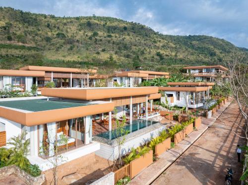 an aerial view of a building with a mountain in the background at Amaya Kampot Homestays in Kampot
