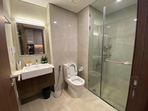 a bathroom with a toilet and a sink and a shower at Lustay StudioH3 Hawaii Masteri- Luxury Furnished in Gia Lâm Pho