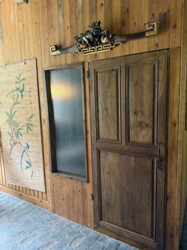 a wooden door and window in a wooden wall at Domaine Les Bertrands in Couches