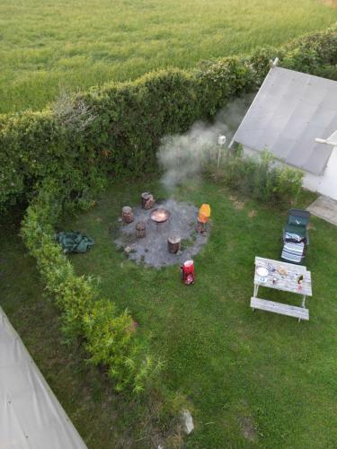 an aerial view of a backyard with a fire pit at Celtic Longhouse Tent at Coverack Camping in Coverack