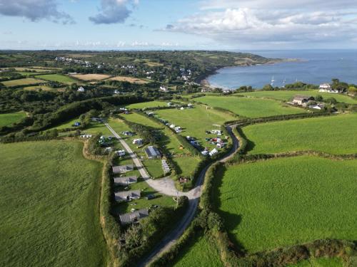 an aerial view of a farm near the ocean at Celtic Longhouse Tent at Coverack Camping in Coverack