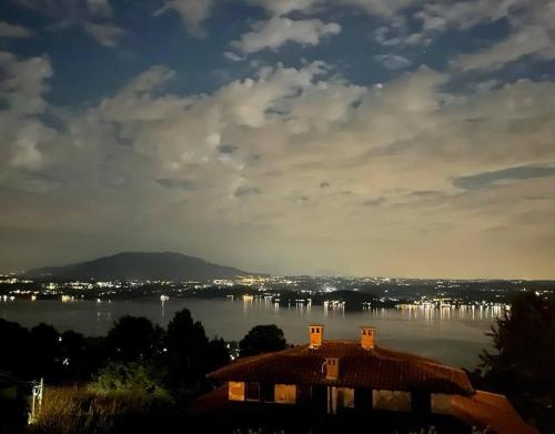 a house sitting on top of a large body of water at Villa Vista Lago in Massino Visconti