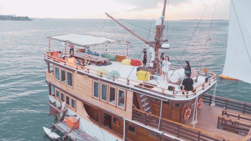 a group of people on a boat in the water at Gallia Phinisi Batam in Sengkuang