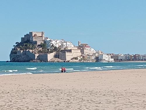 a group of people standing on a beach near the ocean at Albaga in Sant Jordi