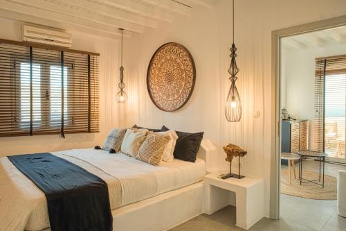 a bedroom with a bed with pillows on it at Santa Maria Hotel in Elia Beach