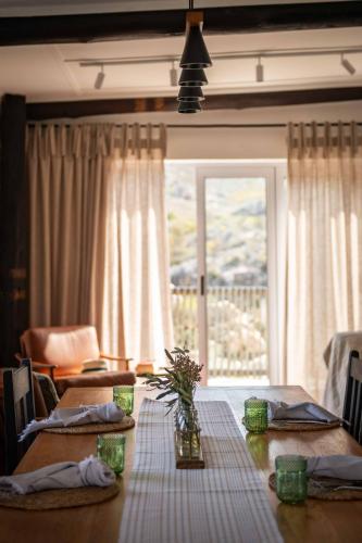 a dining room with two tables and a window at Stayatdestraadt Red Fin Cottage in Op-die-Berg