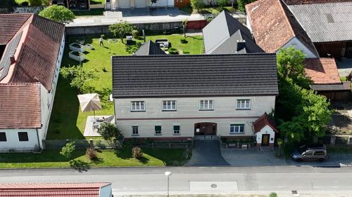 an aerial view of a large white house with a yard at Ferienwohnung Anna in Burgau