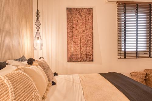 a bedroom with a bed and a window at Santa Maria Hotel in Elia Beach