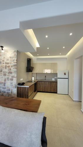 a large kitchen with a wooden table in a room at Vista del sole Kythnos in Kithnos