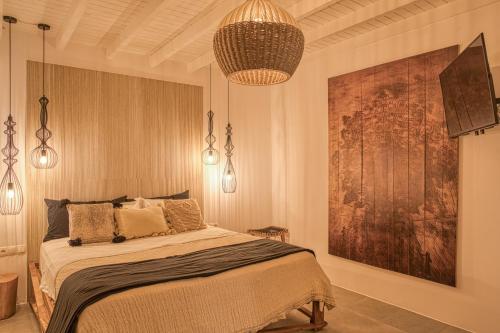 a bedroom with a bed and a large painting at Santa Maria Hotel in Elia Beach