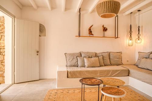 a living room with a couch and two tables at Santa Maria Hotel in Elia Beach
