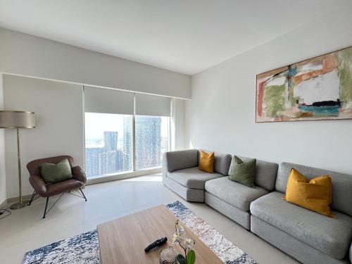 a living room with a couch and a chair at HighFloor 3BR plus Maids GateTower in Abu Dhabi