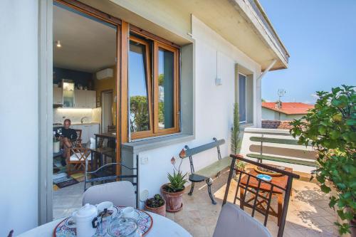 a balcony of a house with a table and chairs at I Levrieri Venezia in Torre del Lago Puccini