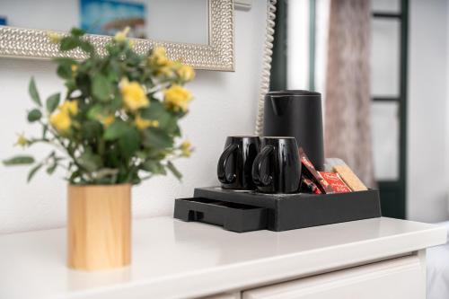 a vase of flowers sitting on top of a counter at Eleni Rooms in Parikia