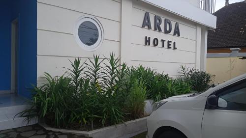 a white building with a sign that reads araba hotel at Hotel Arda Bali in Negara