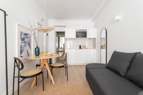 a living room with a couch and a table at Lapa Diplomatic Suites & Flats by Feel Lisboa in Lisbon