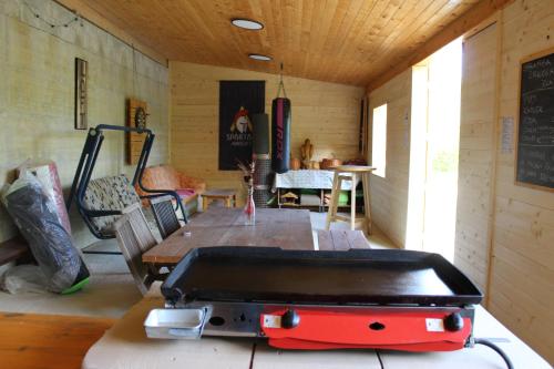 a room with a table and a grill in it at Glamping Zeleni raj Vače in Vače