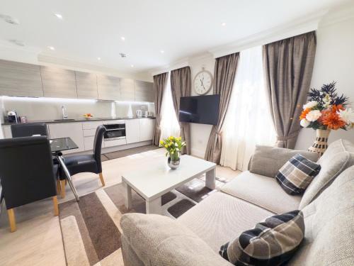 a living room with a couch and a table at Marylebone Executive Apartments in London