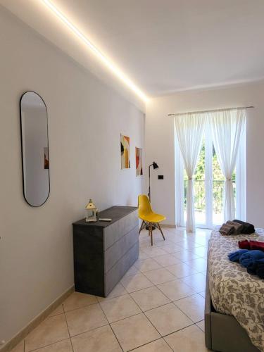 a bedroom with a bed and a dresser and a mirror at Casa Dolce Casa, 10 minuti dal mare di Sestri Levante POSTEGGIO E WIFI in Casarza Ligure