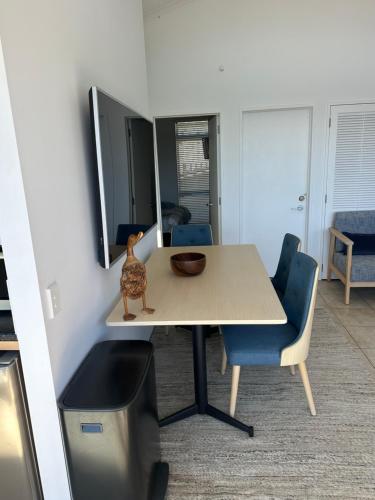 a table with a bowl on it in a room at Deluxe Bedroom ldouble or twin bedl in shared Premium Villa at Waiheke Island Resort in Waiheke Island