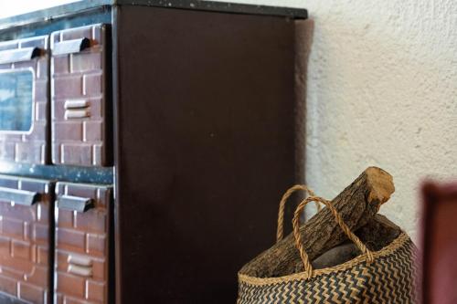 a wicker bag sitting next to a wall at Charming Loft with Lovely Yard in Gázion