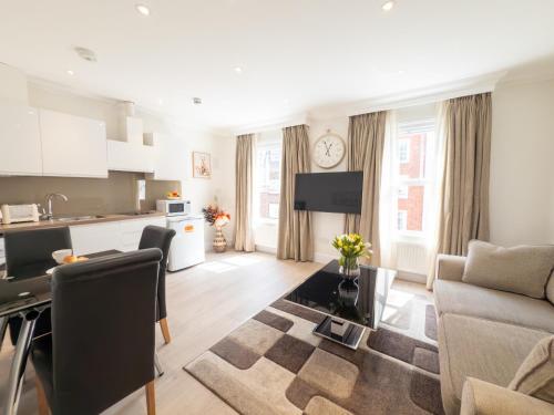 a living room with a couch and a table at Marylebone Executive Apartments in London