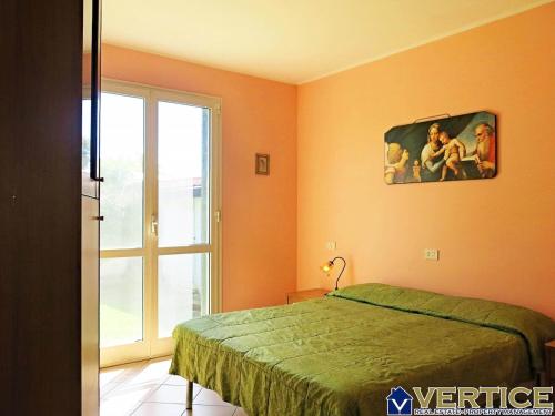 a bedroom with a bed and a painting on the wall at AUGUSTY - Fondi Vertice Houses in Lido Di Fondi