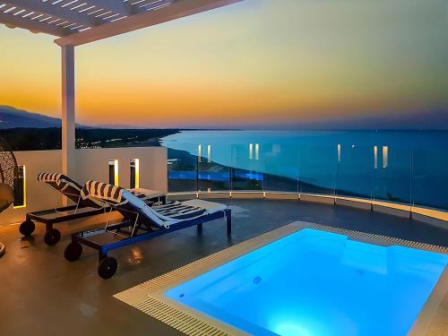 a house with a swimming pool with a view of the ocean at Panorama Suites & Spa - Adults Only in Stomio