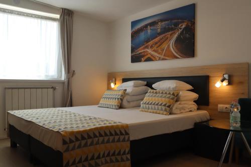 a bedroom with a large bed with pillows at Christina Residence in Budapest