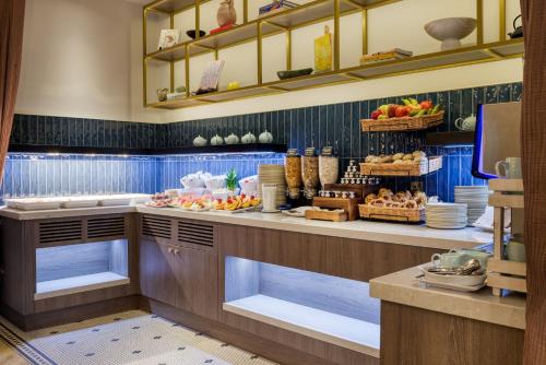 a kitchen with a counter with food on it at The Memoir Club, formerly Ambassadors Bloomsbury in London