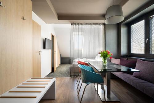 a living room with a table and a couch at Onyx Luxury in Sárvár