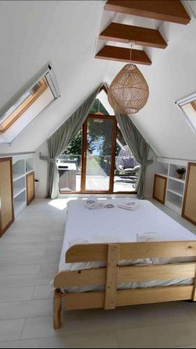 a bedroom with a large bed in a room with windows at Shore of Sapanca Lake Çatı Villa Lakehouse in Kartepe