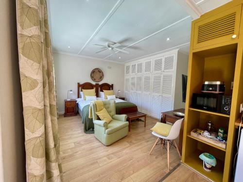 a hotel room with a bed and a couch at Wholeness Accommodation in Hermanus
