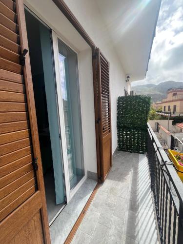 a balcony with a sliding glass door and a view at SteLo Casa Vacanze in Palermo