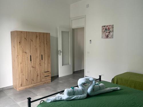 a stuffed elephant laying on a bed in a bedroom at SteLo Casa Vacanze in Palermo