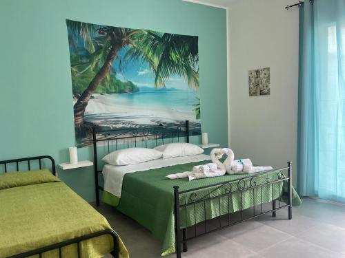 a bedroom with two beds and a painting of a beach at SteLo Casa Vacanze in Palermo