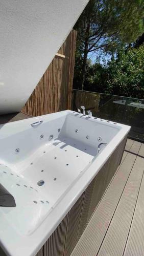 a white bath tub sitting on a deck at Shore of Sapanca Lake Çatı Villa Lakehouse in Kartepe