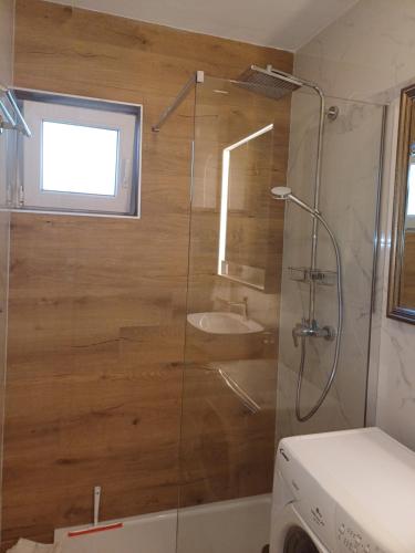 a bathroom with a shower and a sink at Apartman BoloB in Baška