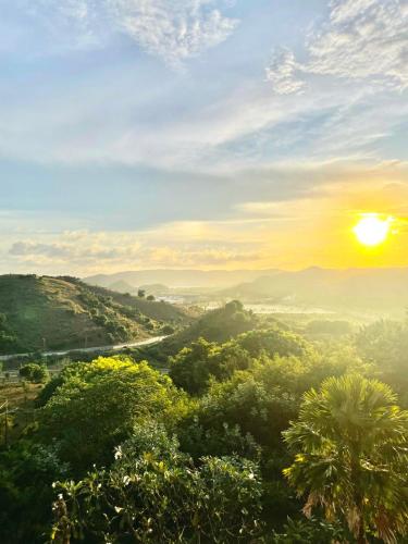 a view of a valley with the sun in the sky at Truntum Boutique Mandalika in Kuta Lombok