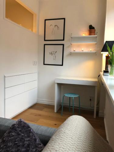 a living room with a table and a blue stool at Apartment in So-Fo at Södermalm 24sqm in Stockholm