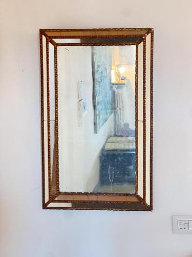 a mirror on a wall with a picture of a staircase at La terrazza di Andrea in Bolsena