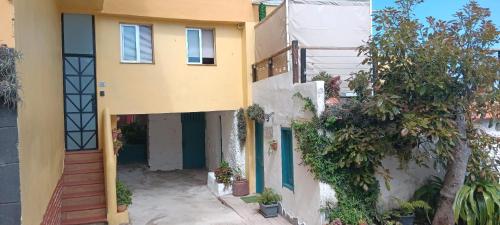 a yellow and white building with a door at Las Vistas Apartament in La Rambla